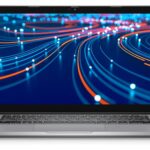 Silver laptop open, displaying a vibrant abstract screen of blue and orange light trails.
