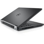 Dell laptop partially open, side view showing USB ports and ventilation grills.