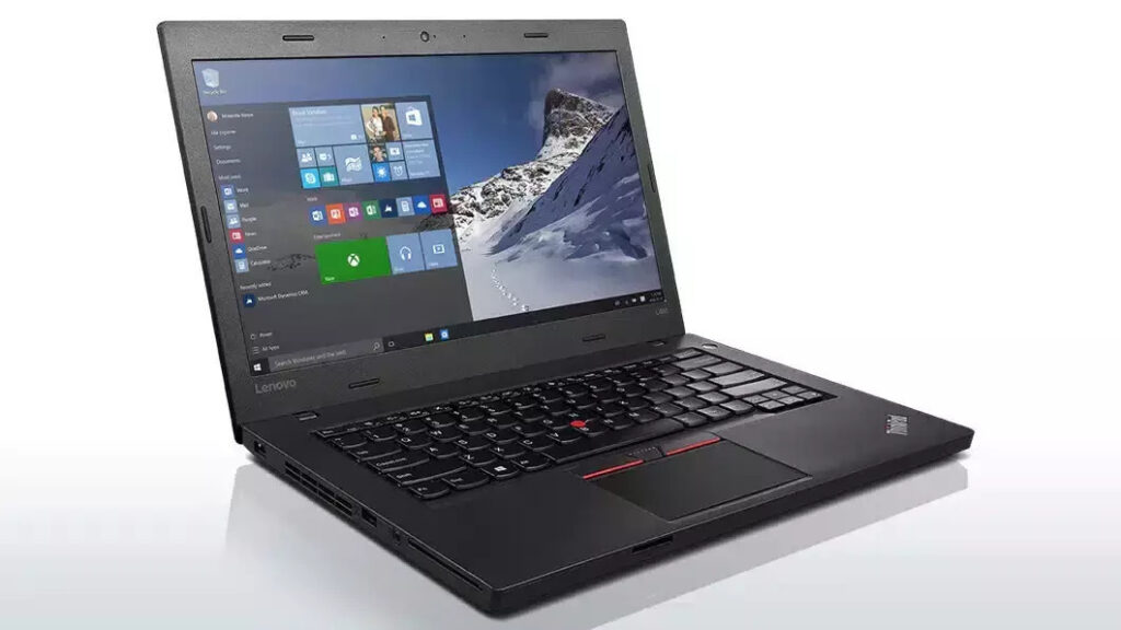 Open Lenovo ThinkPad laptop showing Windows desktop with mountain wallpaper, keyboard, and red TrackPoint in the center of the keyboard.