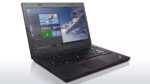 Open Lenovo ThinkPad laptop showing Windows desktop with mountain wallpaper, keyboard, and red TrackPoint in the center of the keyboard.