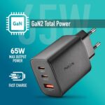 GaN charger with three USB ports showing 65W max output and fast-charge label on a teal background