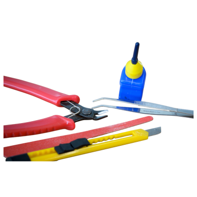 Assorted handheld cutting tools (pliers and utility knives) with a small blue glue bottle on a white background.